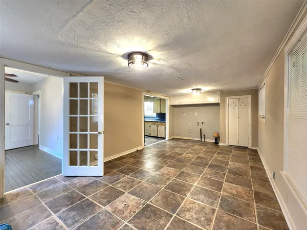 an empty room with a empty space and windows