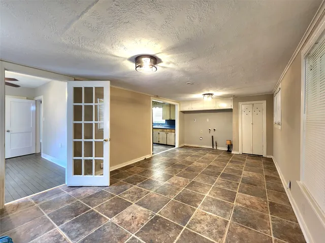 an empty room with a empty space and windows