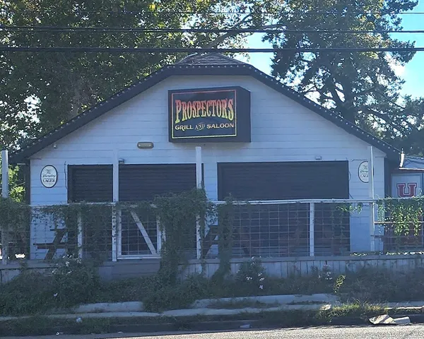 a front view of a retail shop with a outdoor seating space