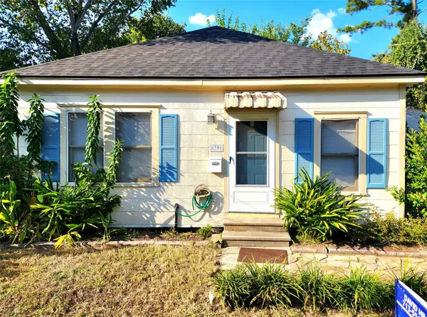a view of a house with potted plants