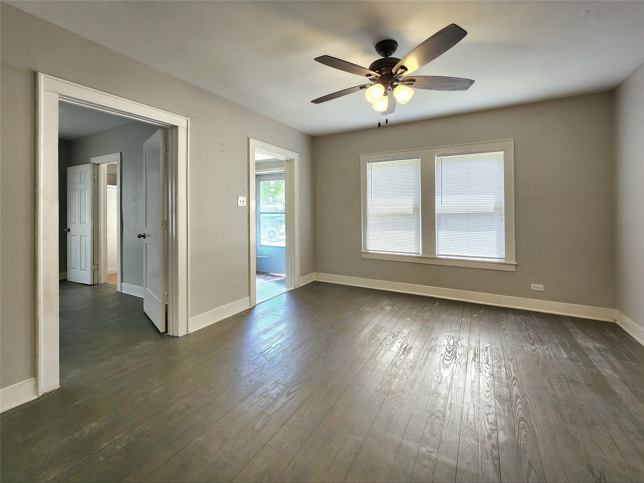6306 Stillman Street Houston, TX 77007 - Photo 3 of 19 a view of an empty room with wooden floor and a window