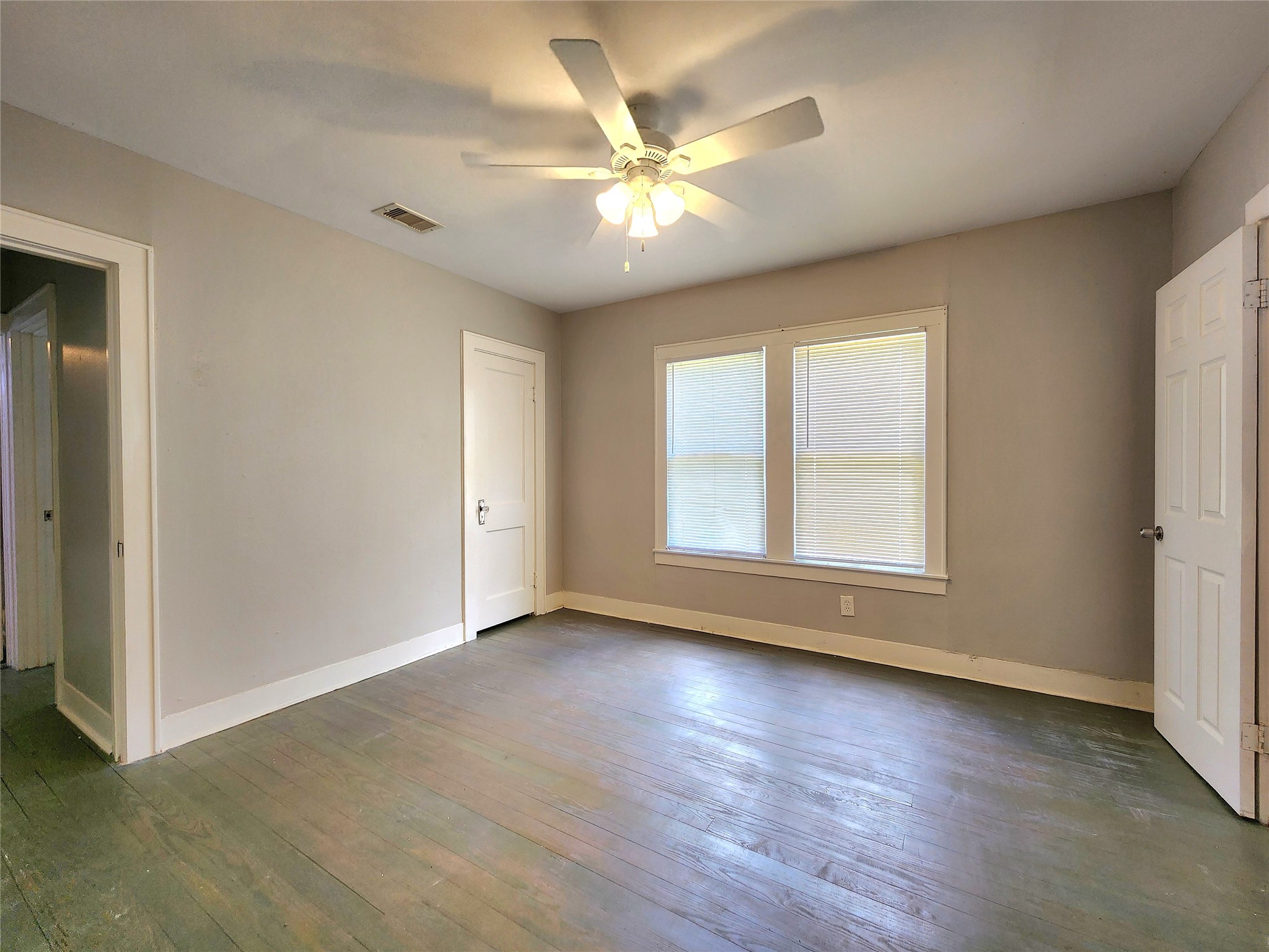 6306 Stillman Street Houston, TX 77007 - Photo 5 of 19 a view of an empty room with wooden floor and a window