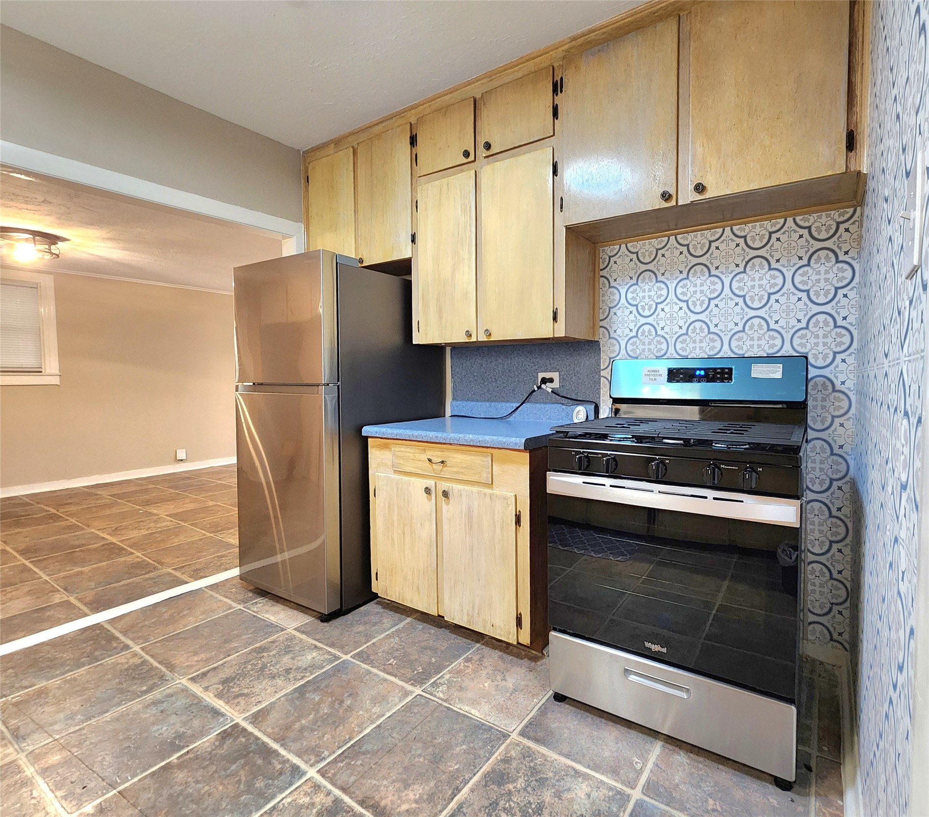 6306 Stillman Street Houston, TX 77007 - Photo 8 of 19 a kitchen with a stove a refrigerator and cabinets
