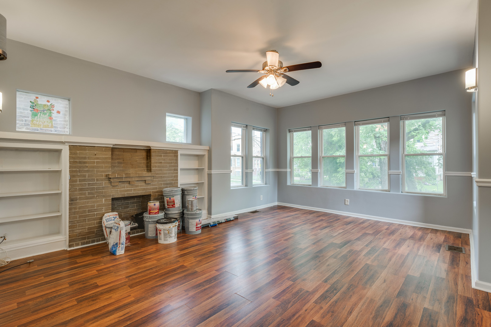 1326 East 72nd Street, Unit 1 Chicago, IL 60619 - Photo 2 of 10 a view of a livingroom with wooden floor and a ceiling fan
