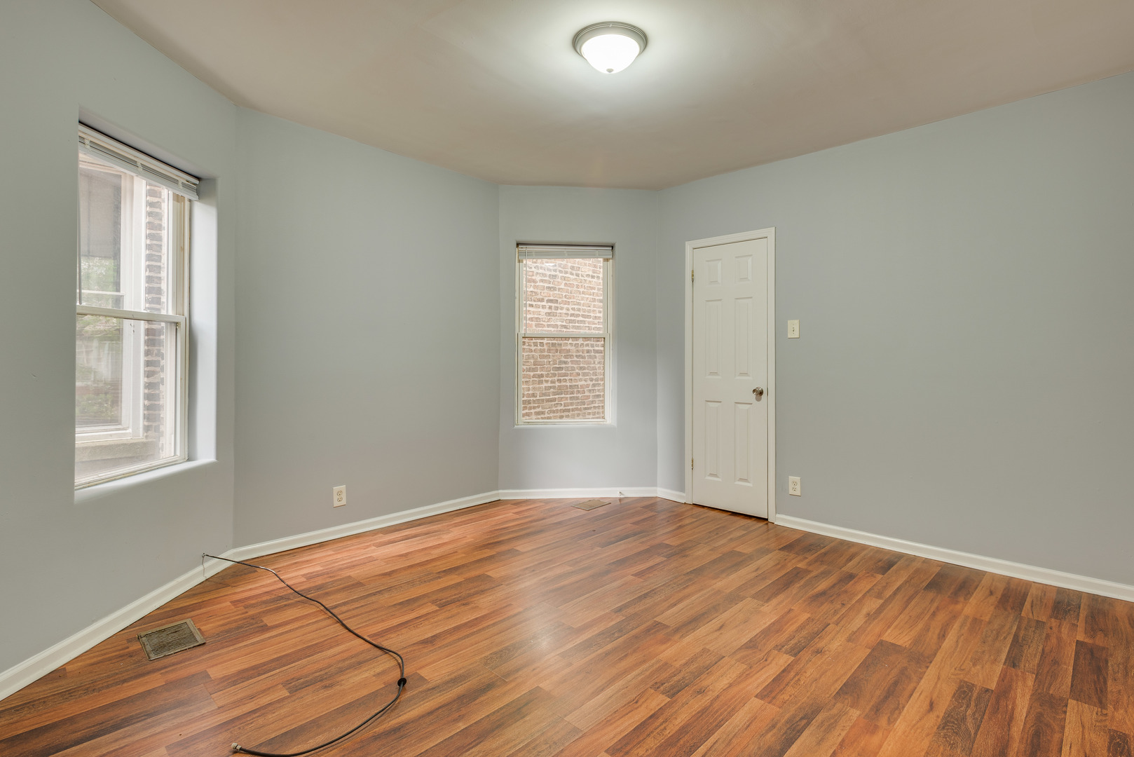1326 East 72nd Street, Unit 1 Chicago, IL 60619 - Photo 4 of 10 a view of an empty room with wooden floor and a window