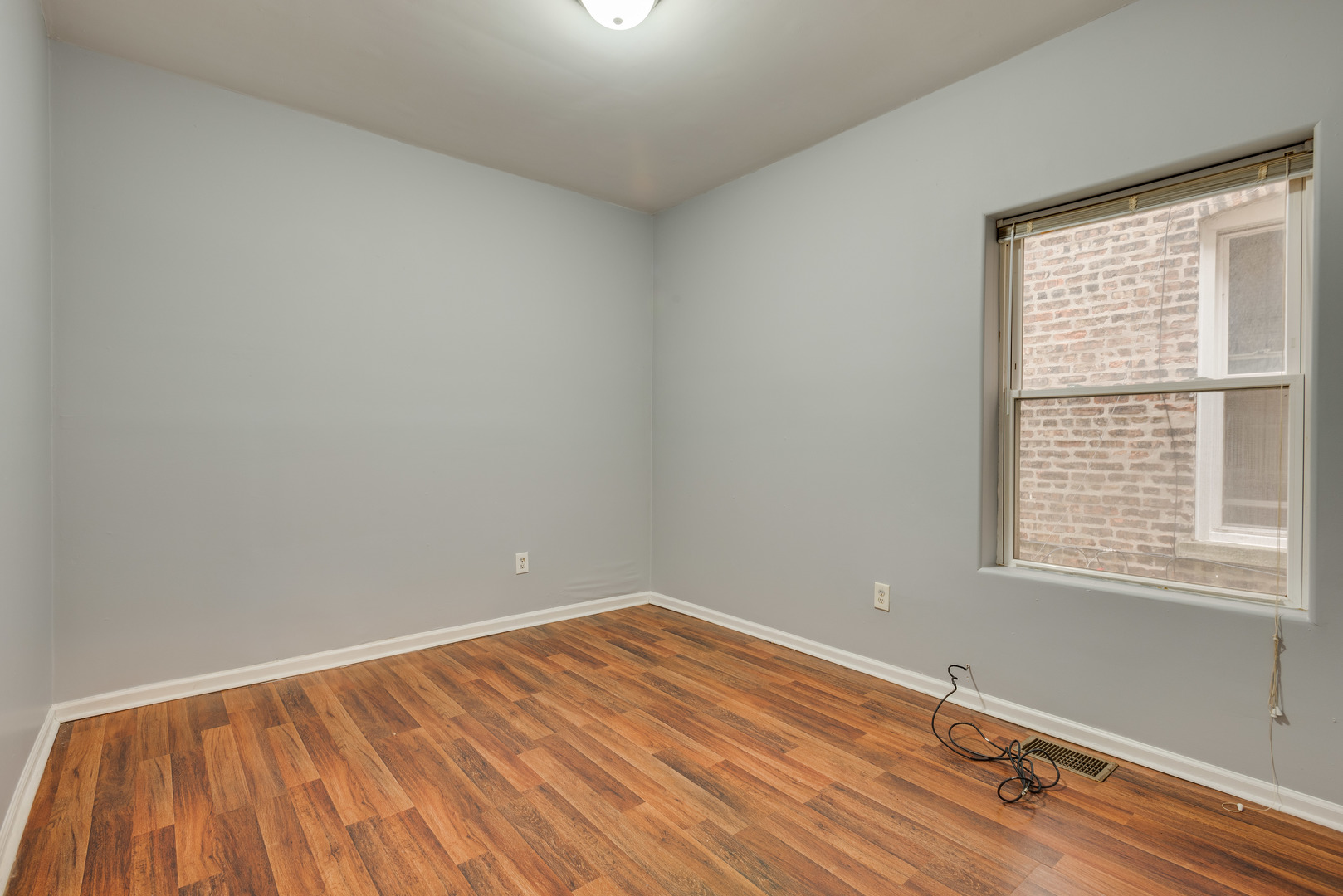 1326 East 72nd Street, Unit 1 Chicago, IL 60619 - Photo 6 of 10 an empty room with a window