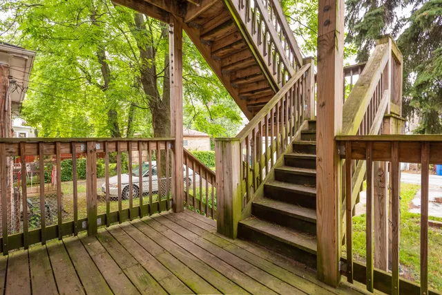 a view of balcony with wooden floor and fence