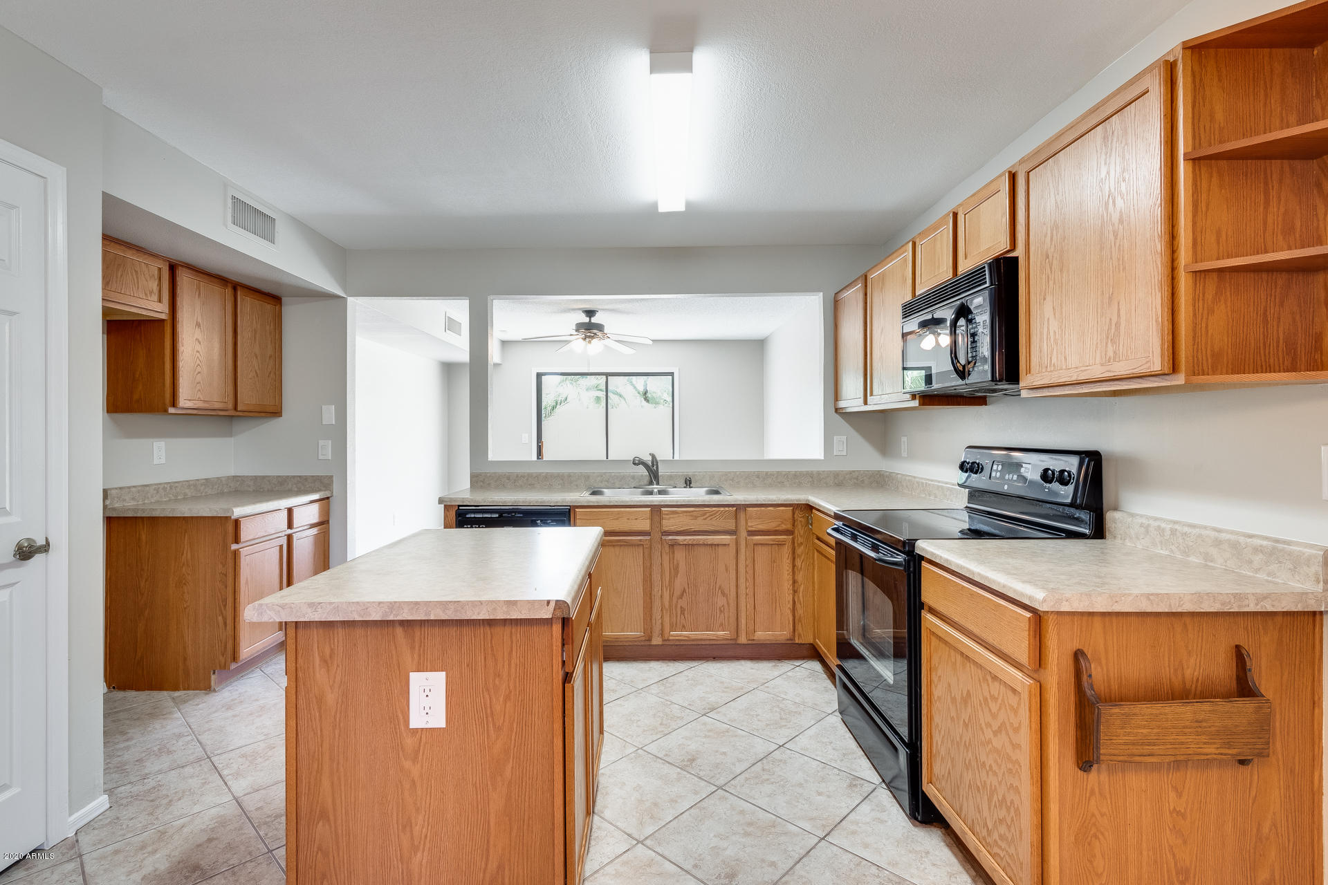 4157 East Agave Road Phoenix, AZ 85044 - Photo 2 of 33 a kitchen with stainless steel appliances granite countertop a sink stove and cabinets