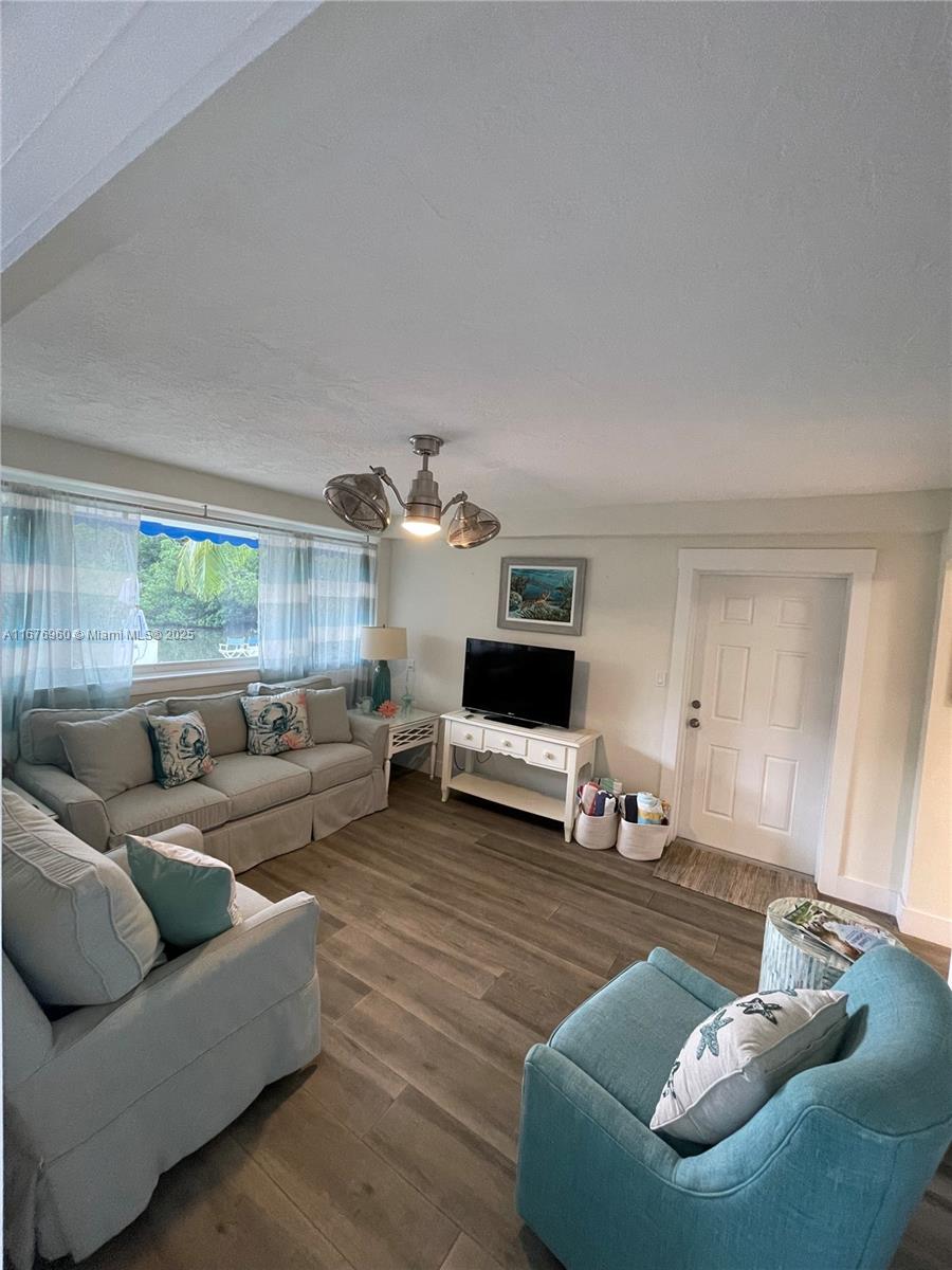 39 Lake Shore Drive Key Largo, FL 33037 - Photo 16 of 27 a living room with furniture and a wooden floor