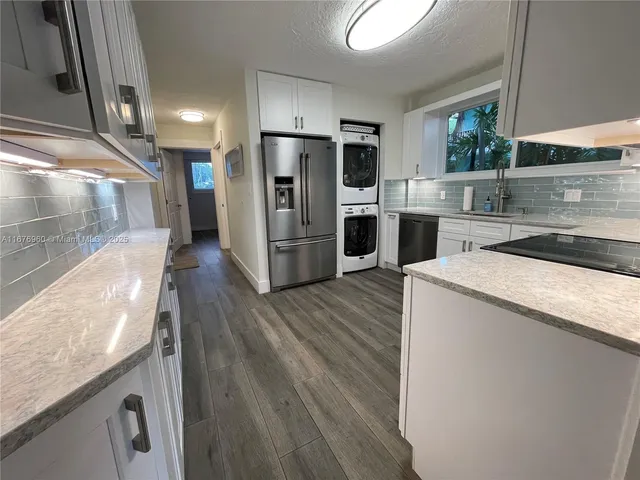 a kitchen with granite countertop a refrigerator and a stove