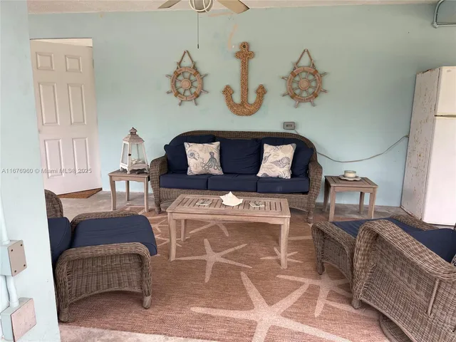 a living room with furniture flowerpot and window