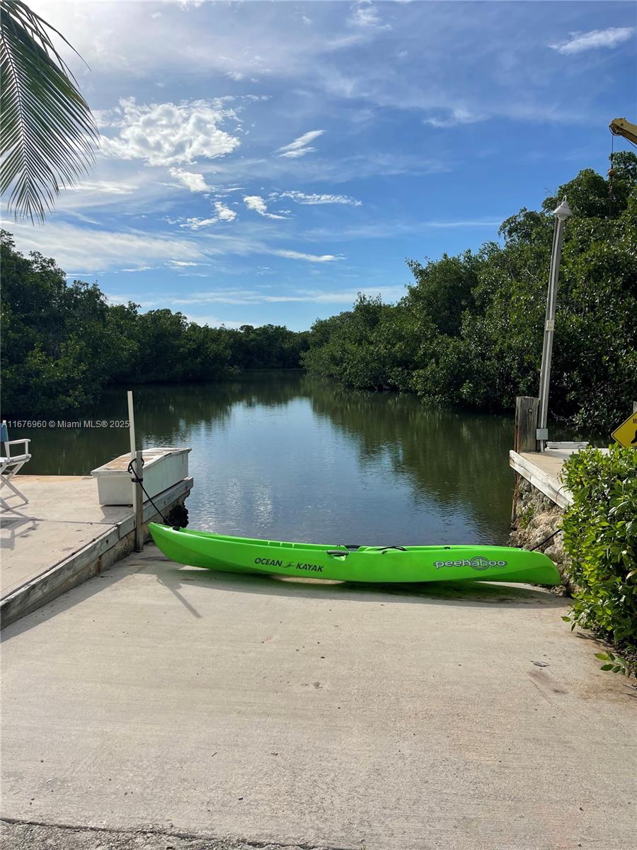 39 Lake Shore Drive Key Largo, FL 33037 - Photo 3 of 27 a view of a lake with a garden