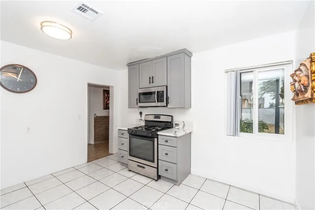 a kitchen with granite countertop cabinets and window