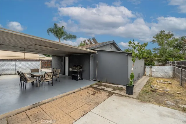 a patio with table and chairs