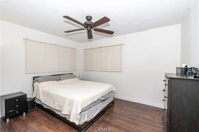 a bed room with a bed and a ceiling fan