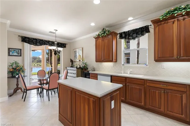 a kitchen with a sink stove and chairs