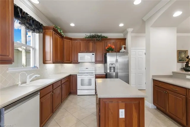 a kitchen with granite countertop a sink stainless steel appliances and cabinets