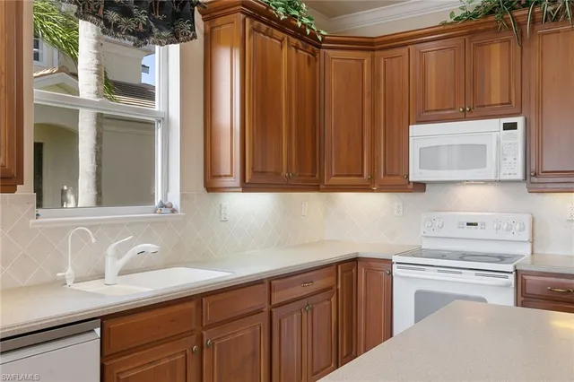 a kitchen with stainless steel appliances wooden cabinets and a sink