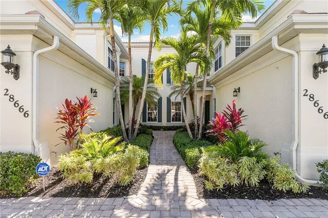a view of a potted flower in front of a house