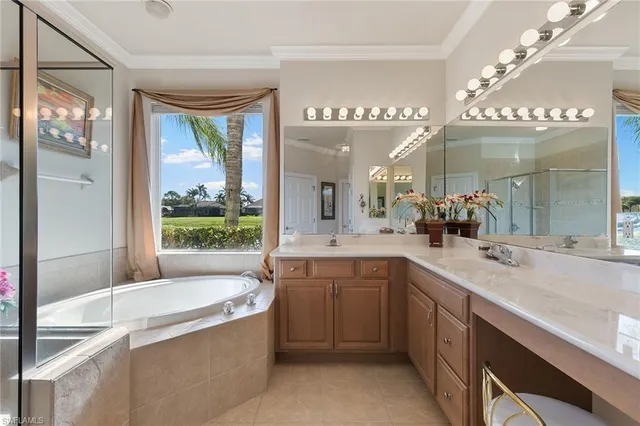 a large bathroom with a large tub and sink
