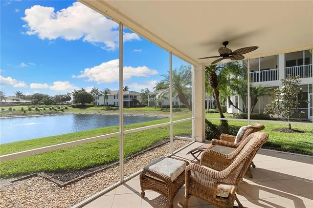 a view of a patio with a table chairs and a lake view
