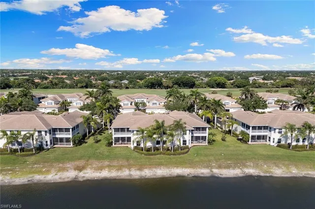 a aerial view of a house with a yard table and chairs