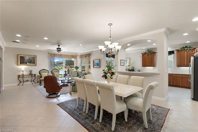 a view of a dining room with furniture and a chandelier