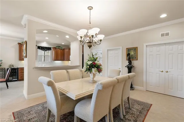 a dining room with furniture and chandelier