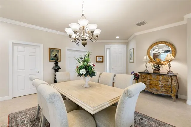 a living room with furniture chandelier and a table