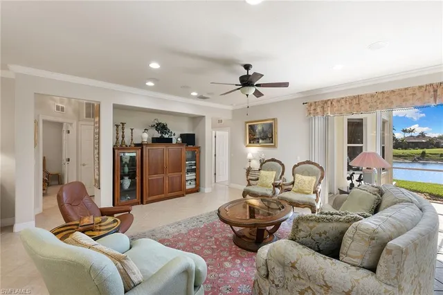 a living room with furniture a ceiling fan and a rug