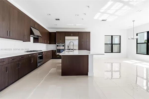 a kitchen with cabinets and stainless steel appliances