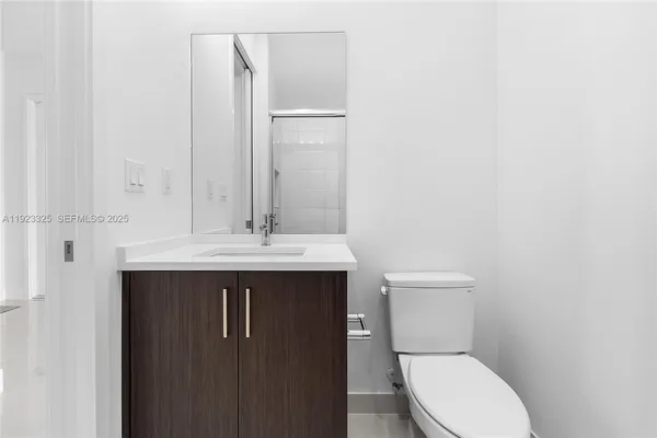 a bathroom with a shower sink and mirror