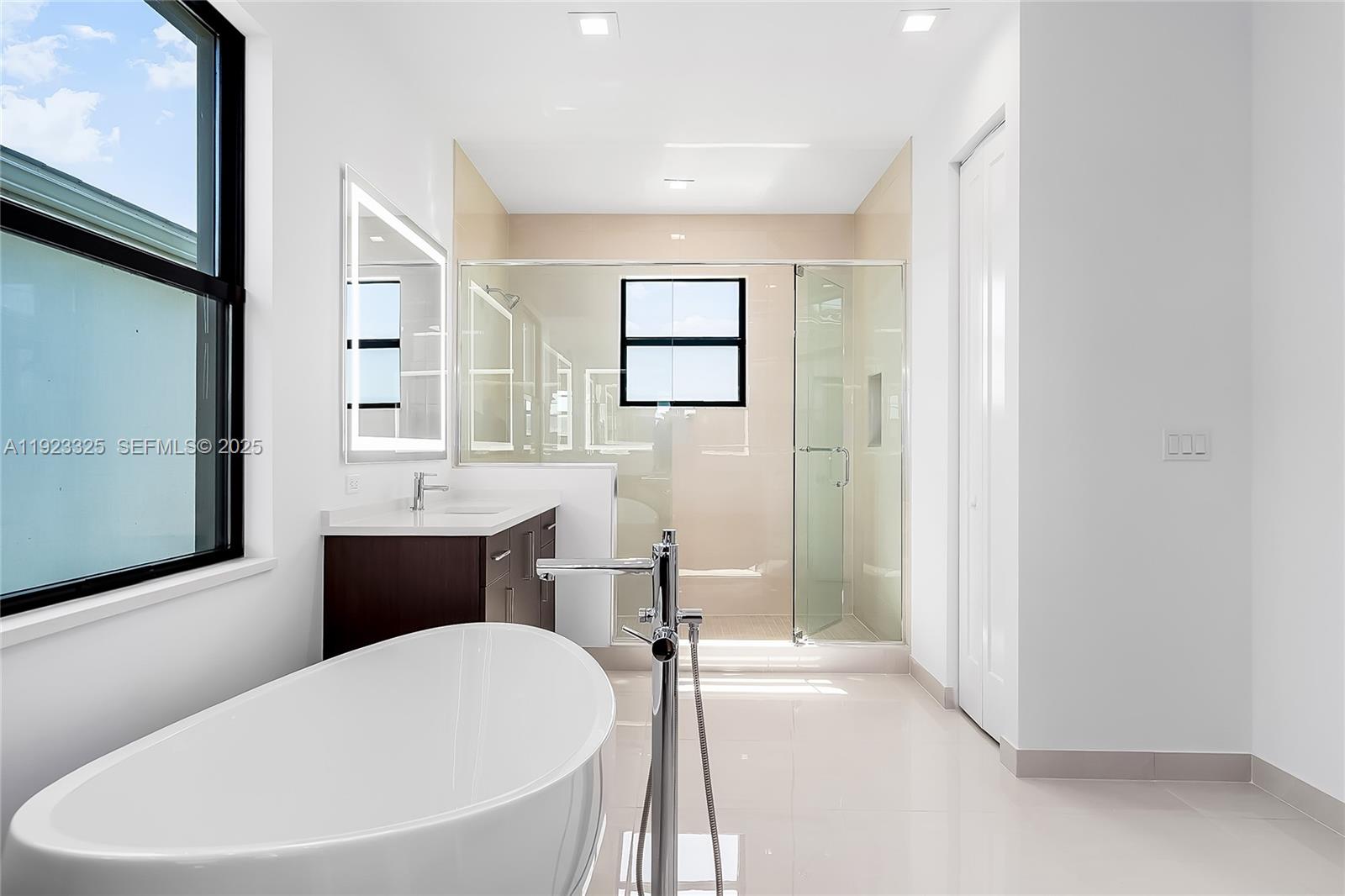 9362 Tulip Leaf Court, Unit 9362 Boca Raton, FL 33434 - Photo 29 of 80 a bathroom with a sink a mirror and a bathtub