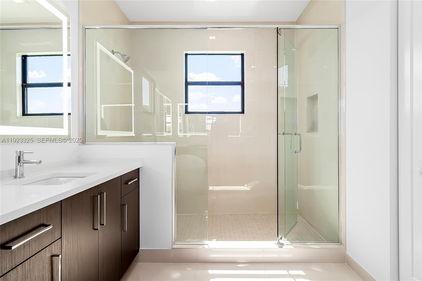 9362 Tulip Leaf Court, Unit 9362 Boca Raton, FL 33434 - Photo 33 of 80 a bathroom with a shower sink and mirror
