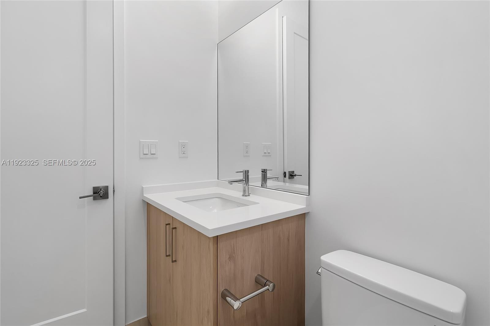 9362 Tulip Leaf Court, Unit 9362 Boca Raton, FL 33434 - Photo 43 of 80 a bathroom with a toilet a sink and mirror