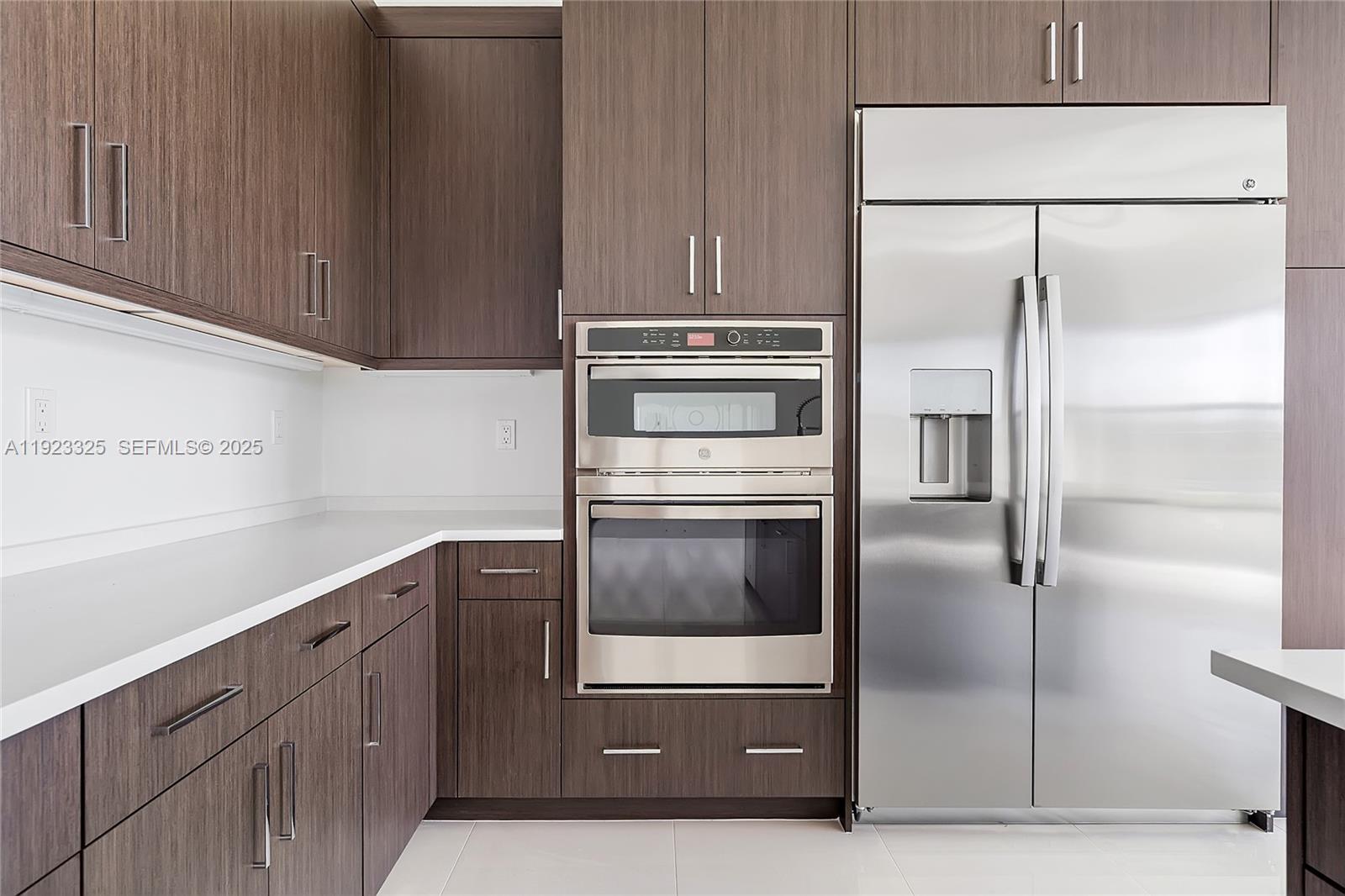 9362 Tulip Leaf Court, Unit 9362 Boca Raton, FL 33434 - Photo 6 of 80 a kitchen with cabinets and stainless steel appliances