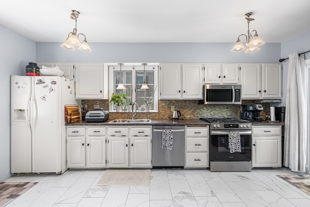 3 Fitz Road Peabody, MA 01960 - Photo 5 of 34 a kitchen with white cabinets and white appliances