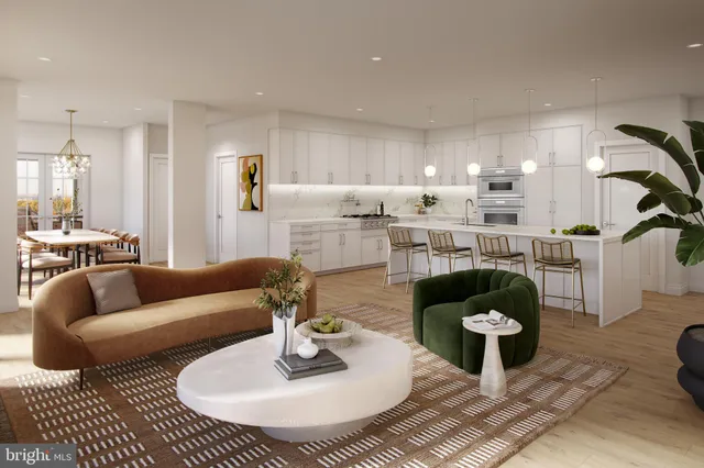 a living room with furniture and a dining table with kitchen view