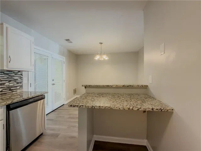 a view of kitchen with sink stove and refrigerator