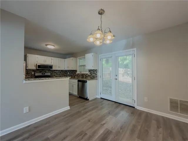 a view of a kitchen with electric appliances