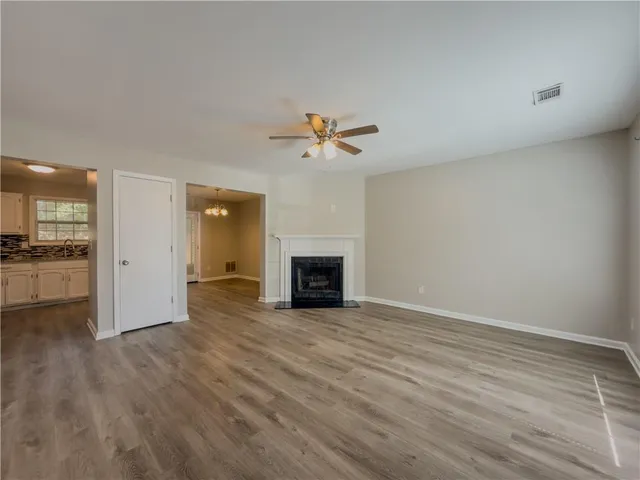 a view of a room wooden floor and a kitchen