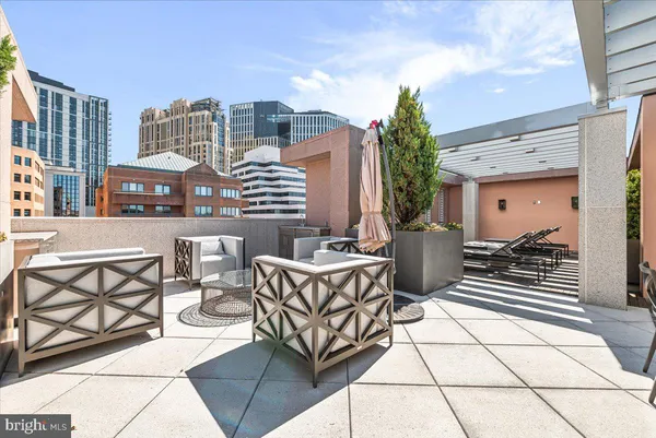 a view of a patio with couches table and chairs and potted plants