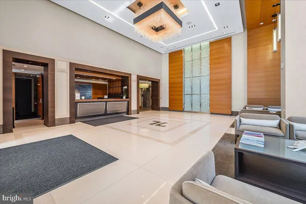 a dining hall with stainless steel appliances granite countertop a stove and a sink with couches