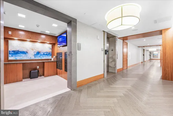 a open kitchen with stainless steel appliances kitchen island a refrigerator and a microwave