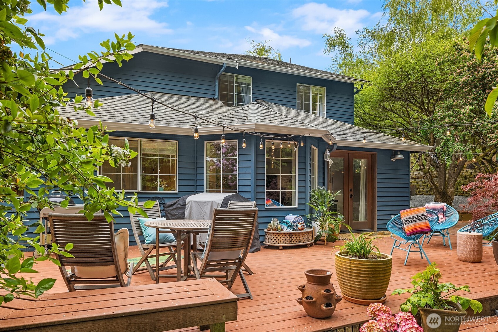 4938 Narbeck Avenue Everett, WA 98203 - Photo 24 of 40 a view of a patio with table and chairs potted plants and floor to ceiling window and potted plants