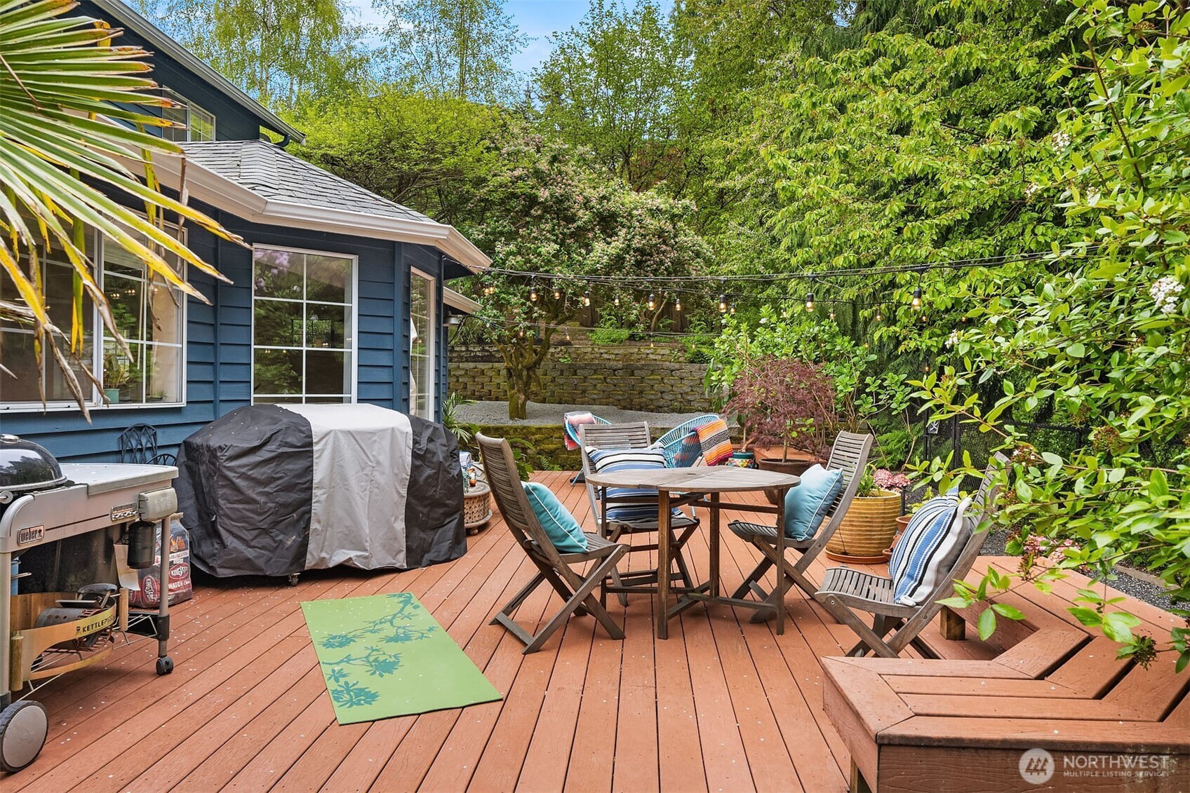 4938 Narbeck Avenue Everett, WA 98203 - Photo 25 of 40 a view of a patio with table and chairs with wooden floor and fence