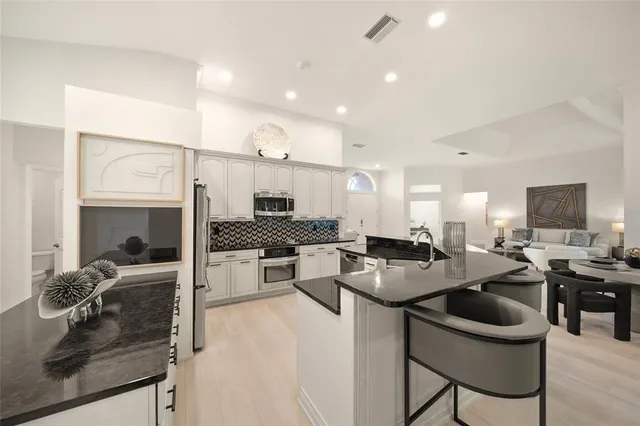 a spacious bedroom with a bed and a flat screen tv