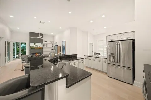 a spacious bedroom with a bed and a flat screen tv