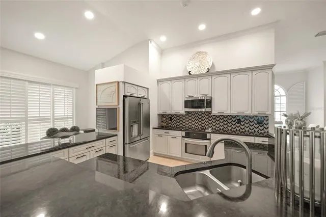 a large bathroom with a granite countertop sink a toilet a mirror and shower