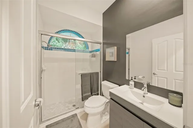 an aerial view of residential houses with outdoor space and lake view in back